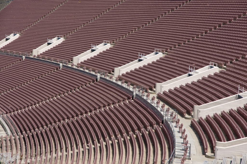 Close up of empty seats at a large football arena.